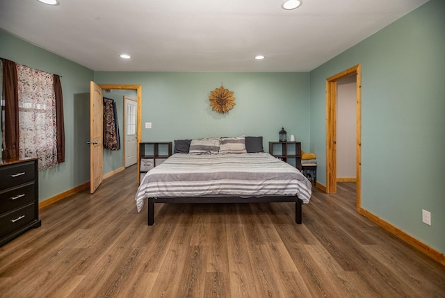 bedroom with dark hardwood / wood-style floors