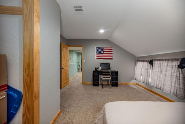 carpeted bedroom with lofted ceiling