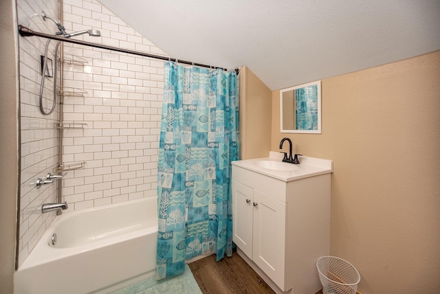 bathroom featuring lofted ceiling, a textured ceiling, vanity, shower / bath combo, and hardwood / wood-style floors