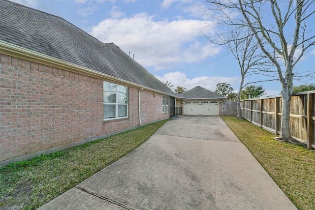 view of home's exterior with a garage and a yard