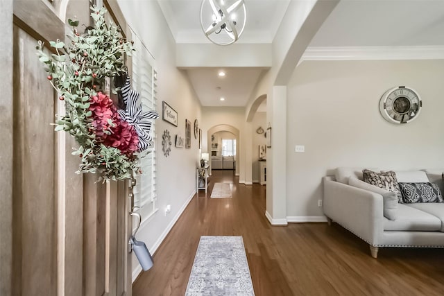 hall with ornamental molding and dark hardwood / wood-style floors