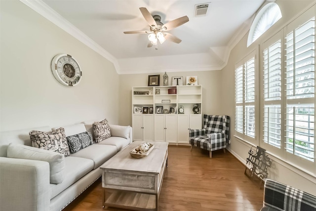 living room featuring ceiling fan, ornamental molding, dark hardwood / wood-style floors, and a healthy amount of sunlight