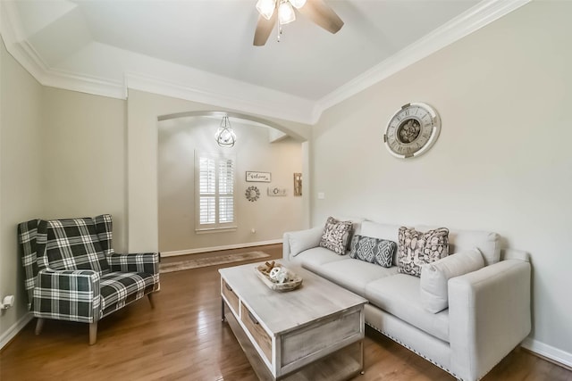 living room with ornamental molding, ceiling fan, and dark hardwood / wood-style flooring