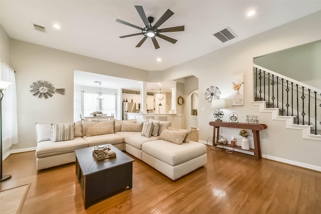 living room featuring hardwood / wood-style flooring and ceiling fan