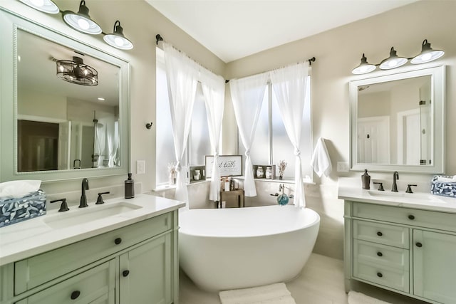 bathroom featuring a washtub and vanity