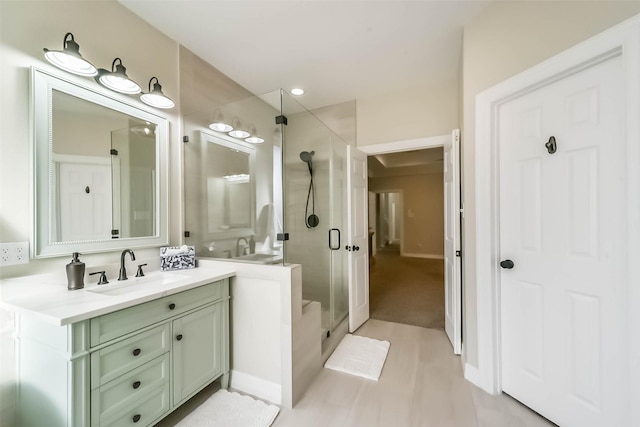 bathroom with walk in shower and vanity