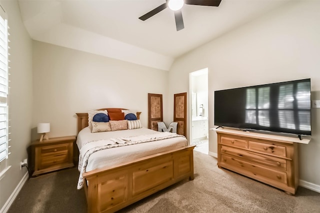 carpeted bedroom with ensuite bathroom and ceiling fan