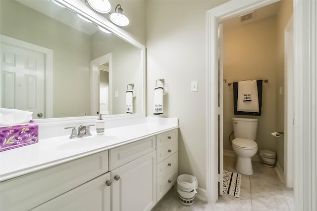 bathroom with vanity, tile patterned floors, and toilet