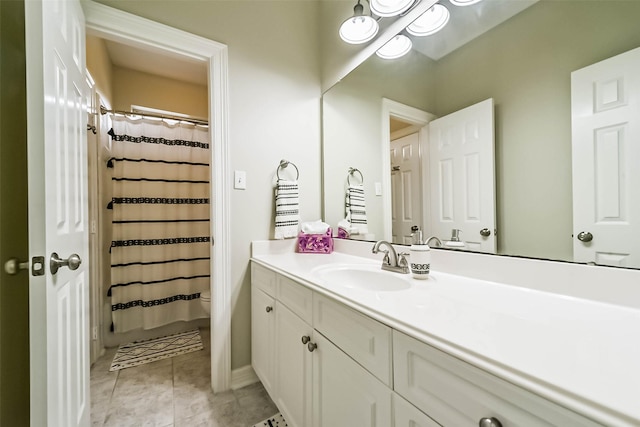 bathroom featuring vanity, a shower with shower curtain, tile patterned floors, and toilet