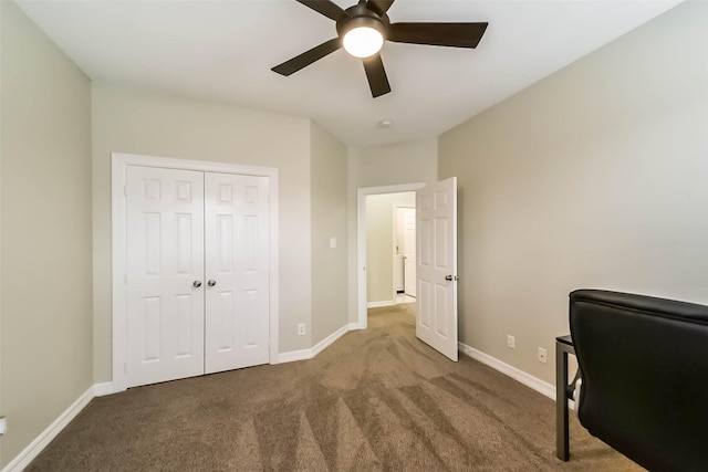 carpeted home office featuring ceiling fan