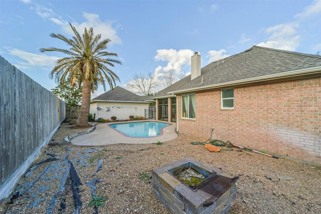 view of swimming pool with a patio area and an outdoor fire pit