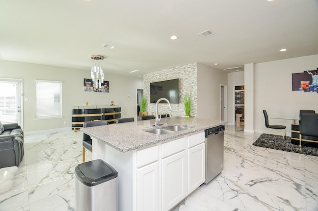 kitchen featuring sink, white cabinetry, light stone counters, a center island with sink, and stainless steel dishwasher