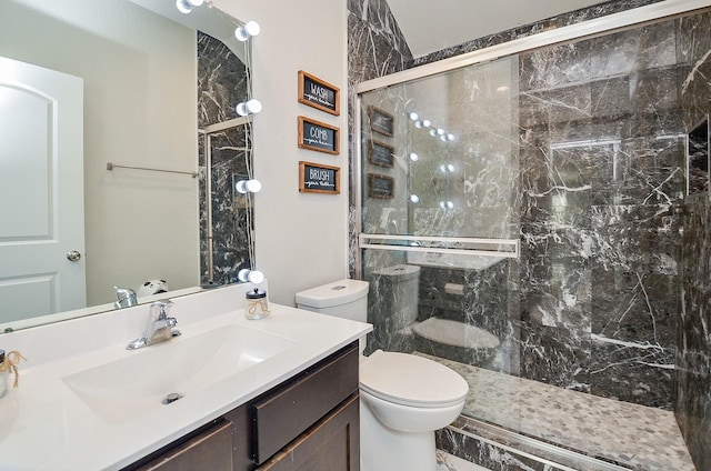 bathroom featuring walk in shower, vanity, and toilet