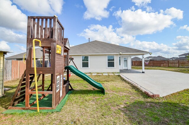 view of jungle gym featuring a patio and a lawn