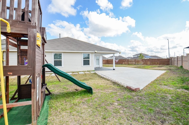 view of yard featuring a playground and a patio area