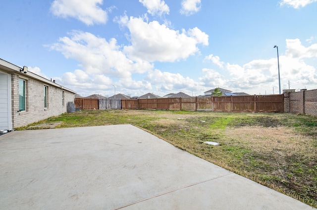 view of yard featuring cooling unit and a patio area