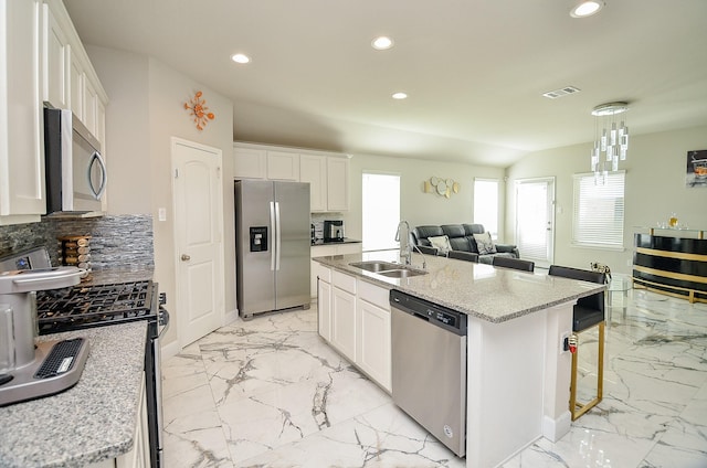 kitchen featuring white cabinetry, sink, a kitchen island with sink, and appliances with stainless steel finishes