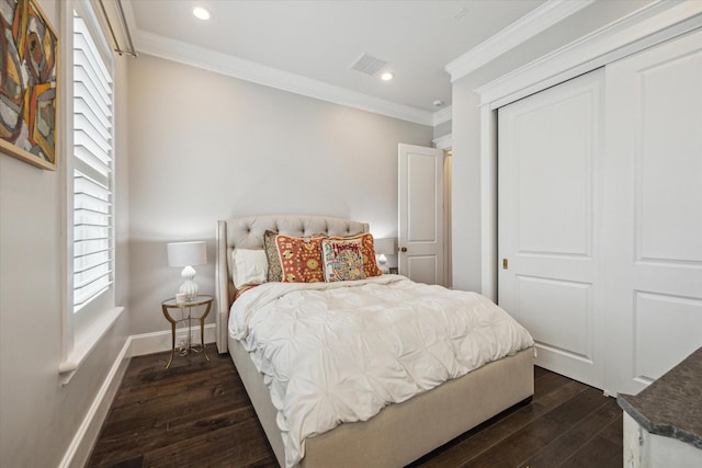 bedroom featuring ornamental molding, dark hardwood / wood-style flooring, and a closet