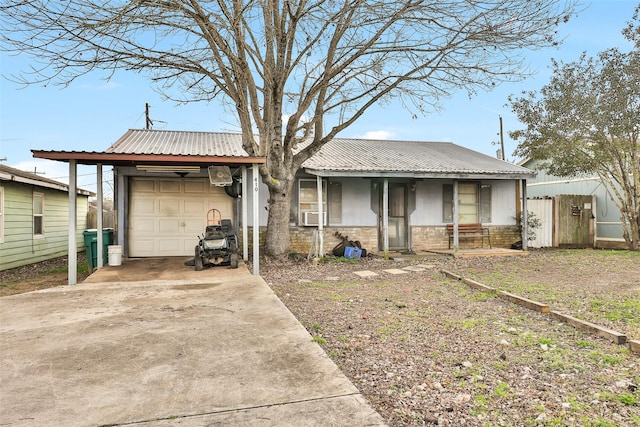 view of front of house featuring cooling unit, a garage, and a carport