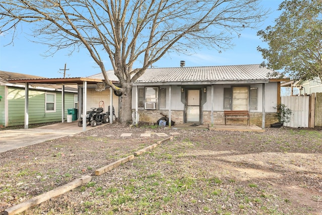 view of front of property featuring cooling unit and a carport