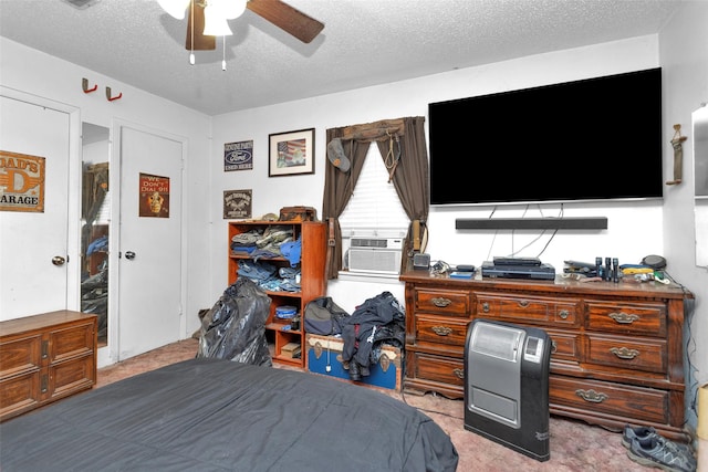 carpeted bedroom featuring ceiling fan, cooling unit, and a textured ceiling