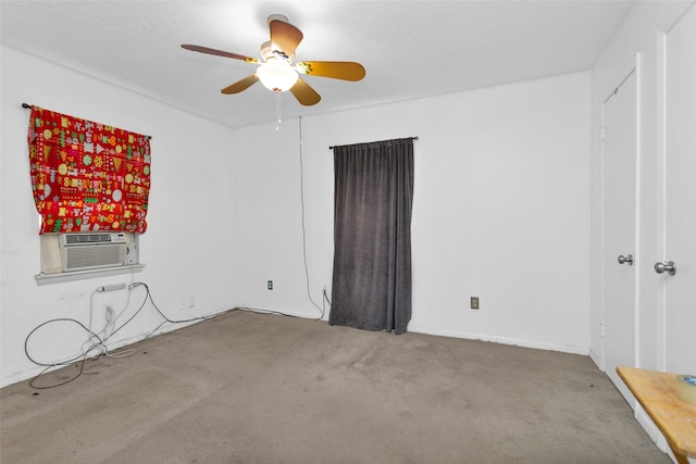 unfurnished room with cooling unit, a textured ceiling, and carpet