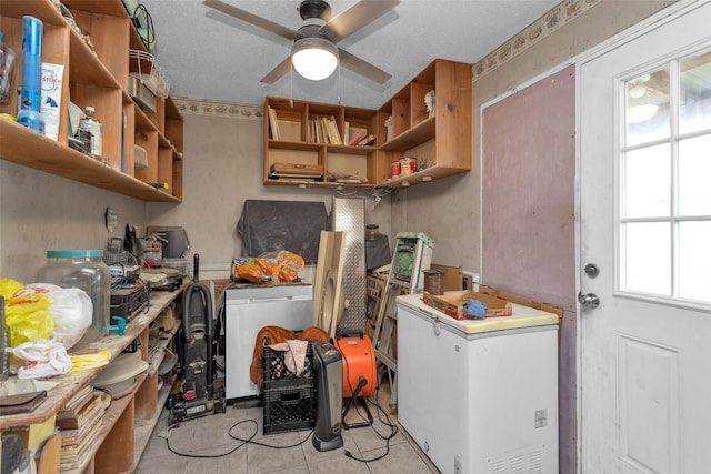 laundry room with ceiling fan, washer / dryer, a textured ceiling, and light tile patterned floors