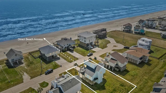 birds eye view of property with a view of the beach and a water view