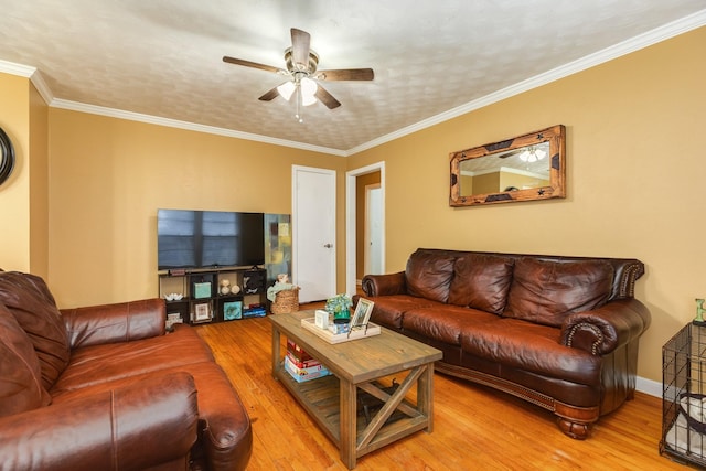 living room featuring hardwood / wood-style flooring, crown molding, and ceiling fan