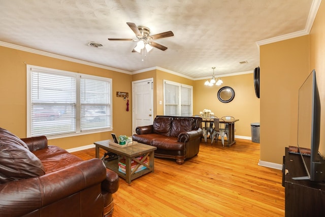 living room featuring crown molding, ceiling fan with notable chandelier, a textured ceiling, and light wood-type flooring