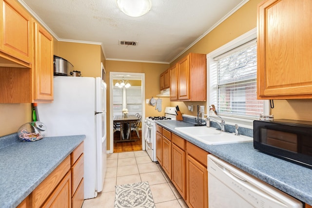 kitchen with sink, crown molding, an inviting chandelier, light tile patterned floors, and white appliances