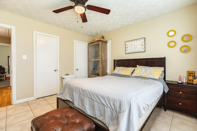 tiled bedroom featuring ceiling fan