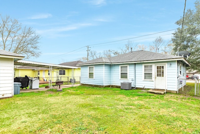 back of house with central AC unit, a pergola, a patio area, and a lawn