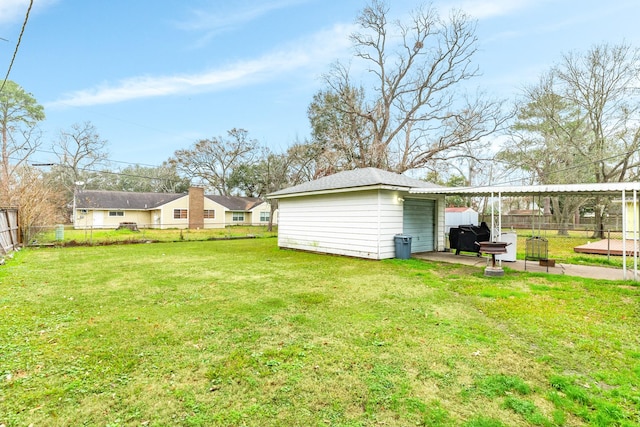 view of yard featuring an outdoor structure and a patio area