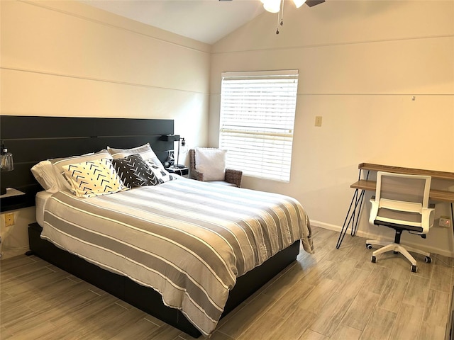 bedroom with vaulted ceiling, ceiling fan, and light wood-type flooring