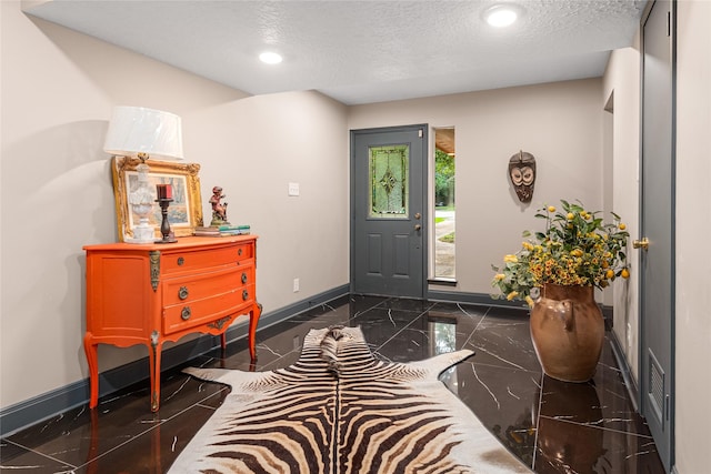 entrance foyer with a textured ceiling