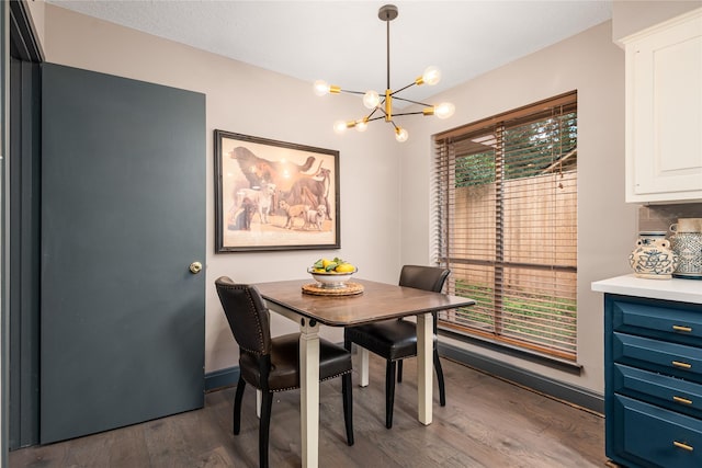 dining space featuring an inviting chandelier, plenty of natural light, and dark hardwood / wood-style floors