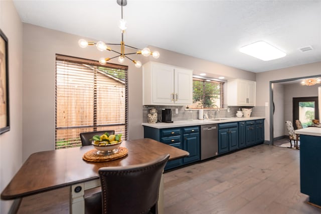 kitchen with pendant lighting, dishwasher, white cabinetry, tasteful backsplash, and blue cabinets