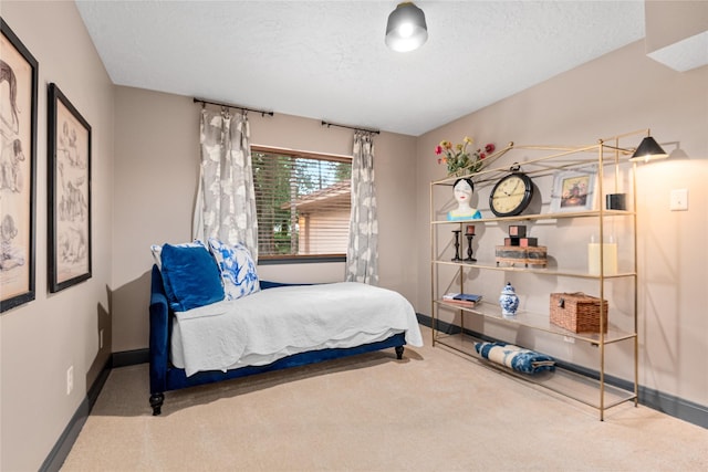 carpeted bedroom featuring a textured ceiling