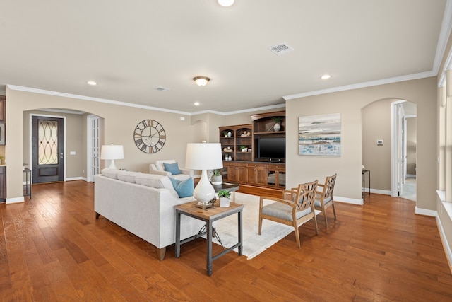 living area featuring arched walkways, recessed lighting, and visible vents
