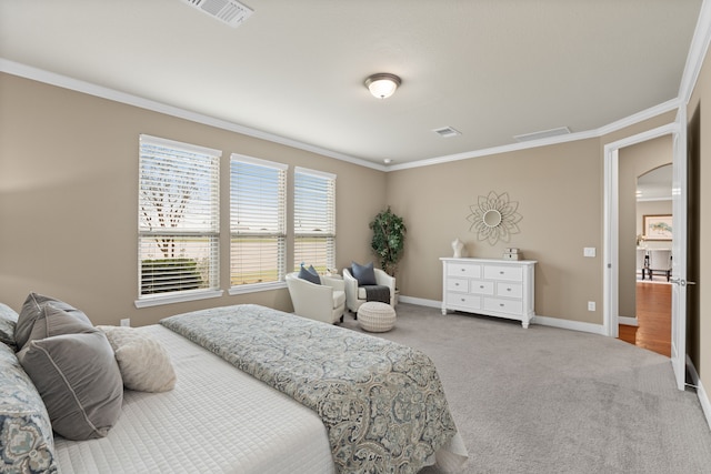carpeted bedroom featuring ornamental molding, arched walkways, baseboards, and visible vents