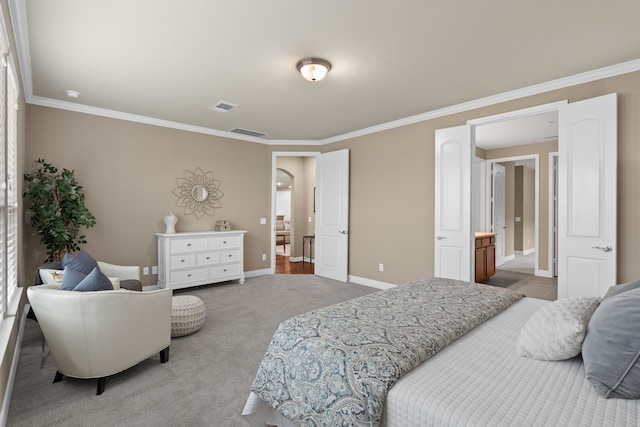 carpeted bedroom with baseboards, visible vents, and crown molding