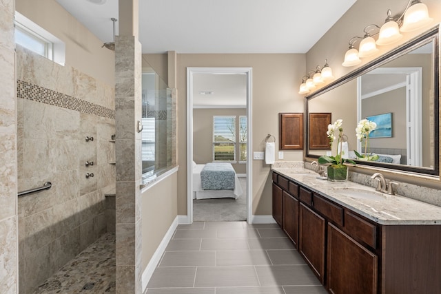 ensuite bathroom with walk in shower, connected bathroom, and a sink