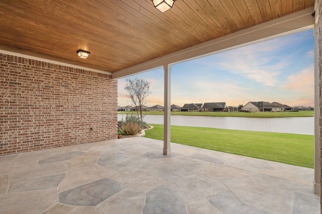 view of patio featuring a water view and a residential view