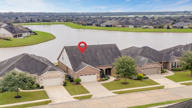 aerial view featuring a water view and a residential view