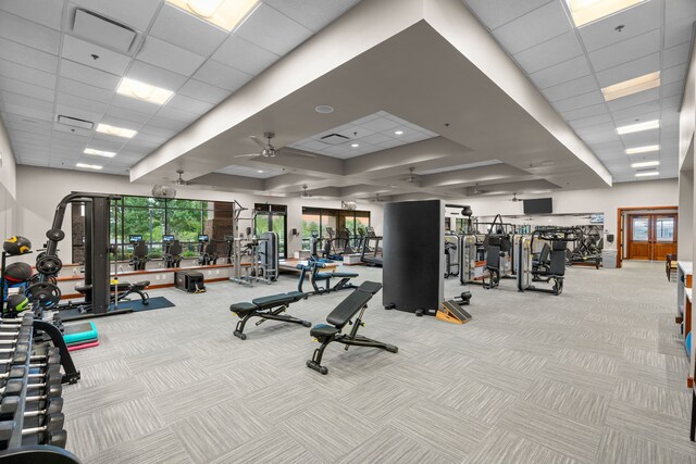 gym featuring carpet flooring, a drop ceiling, a ceiling fan, and visible vents