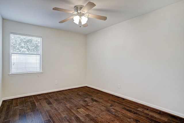 empty room with dark hardwood / wood-style flooring and ceiling fan