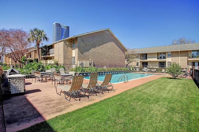 view of pool with a yard