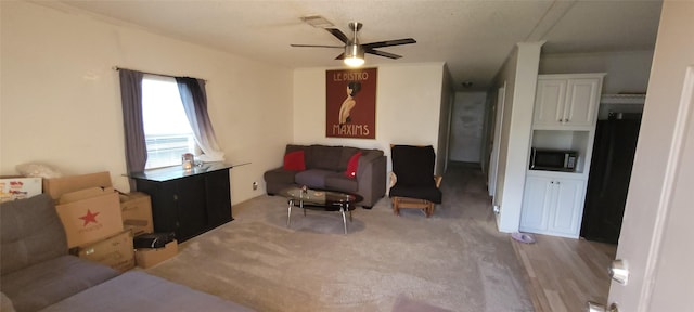 carpeted living room featuring ceiling fan