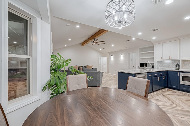 kitchen with appliances with stainless steel finishes, decorative light fixtures, white cabinetry, light parquet floors, and blue cabinetry